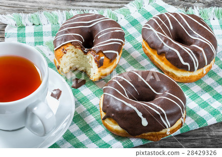 Donuts with Chocolate Icing, a cup of tea 28429326