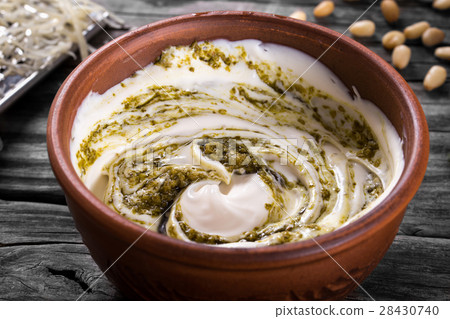 Pesto sauce with Greek yogurt in a bowl Pesto sauce with Greek yogurt in a bowl 28430740