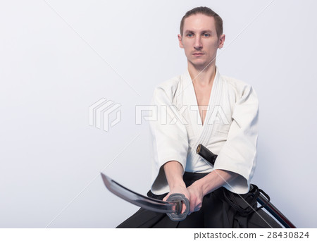 A man with katana on Iaido practice A man with katana on Iaido practice 28430824