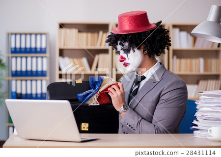The clown businessman working in the office The clown businessman working in the office 28431114