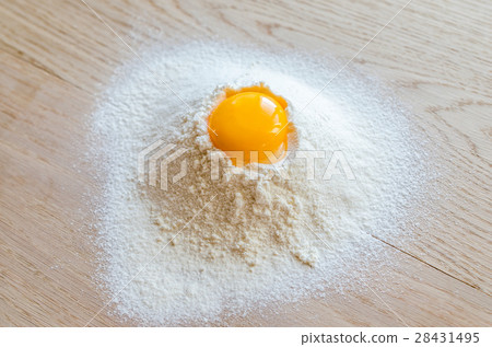 Broken egg in flour Broken egg in flour 28431495