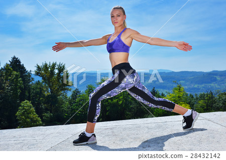 healthy young pretty woman stretching her leg healthy young pretty woman stretching her leg 28432142