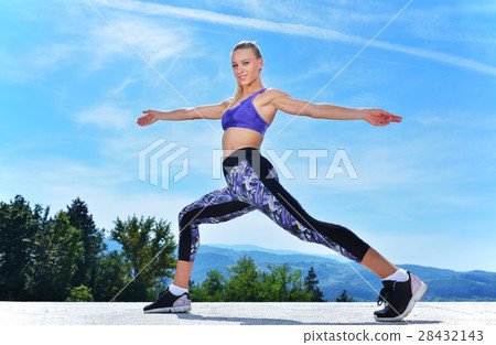 healthy young pretty woman stretching her leg healthy young pretty woman stretching her leg 28432143