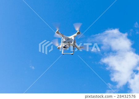 White quadrocopter in blue cloudy sky 28432576