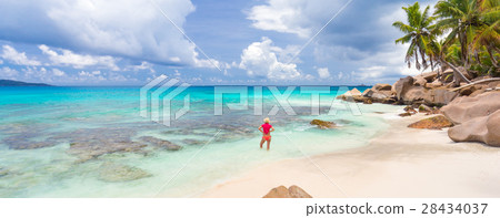 Woman enjoying Anse Patates picture perfect beach 28434037