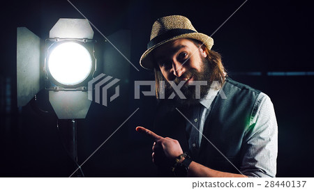 Man turning on studio light 28440137