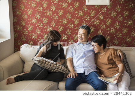 Asian family having fun in the living room together Asian family having fun in the living room together 28441302