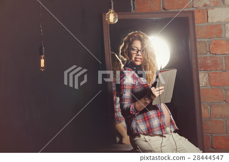 Cute pregnant girl with tablet pc Cute pregnant girl with tablet pc 28444547