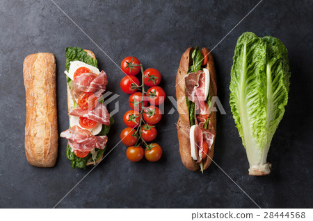 Sandwich with salad, prosciutto and mozzarella 28444568