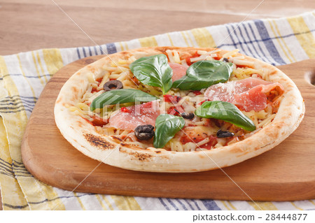 Pizza with raw ham and basil Pizza with raw ham and basil 28444877