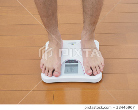 Male foot measuring weight 28446907