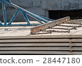 Worker placing cement floor in construction site 28447180