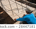 Worker placing cement floor in construction site 28447181
