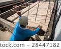 Worker placing cement floor in construction site 28447182