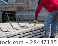 Worker placing cement floor in construction site 28447185