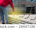 Worker placing cement floor in construction site 28447186