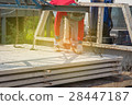 Worker placing cement floor in construction site 28447187
