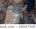 Worker drilling cement concrete floor with machine 28447300