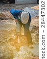 Worker drilling cement concrete floor with machine 28447302