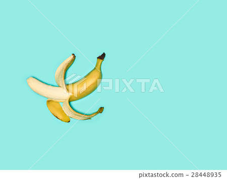 Single banana against blue background 28448935