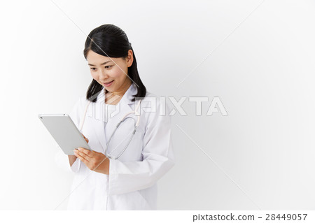 A woman doctor manipulating a mobile terminal A woman doctor manipulating a mobile terminal 28449057