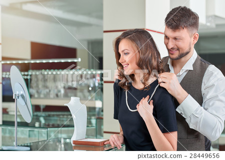 Young man helping his girlfriend with fitting 28449656