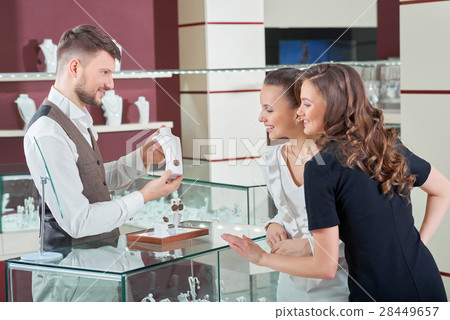 Cheerful female friends shopping jewelry at the 28449657