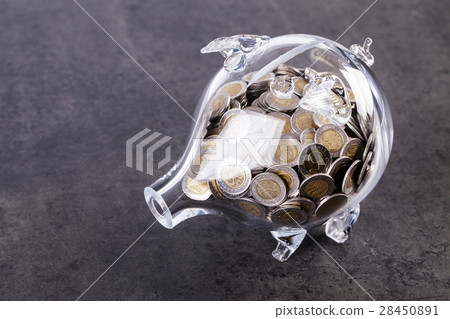 Glass piggy bank with coins inside Glass piggy bank with coins inside 28450891