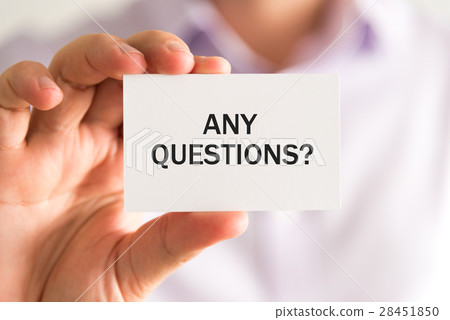 Businessman holding a card with text ANY QUESTIONS Businessman holding a card with text ANY QUESTIONS 28451850