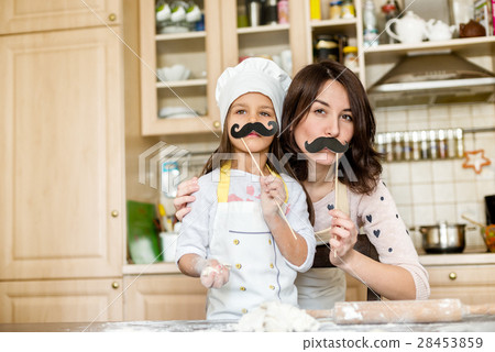 Mother and daughter cooking Mother and daughter cooking 28453859