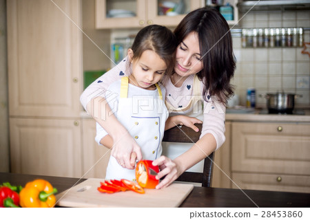 Mother and daughter cooking 28453860