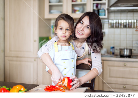 Mother and daughter cooking Mother and daughter cooking 28453877