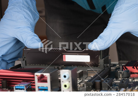 Close up of man hands with gloves installing Ram DDR4 memory mod Close up of man hands with gloves installing Ram DDR4 memory mod 28457018
