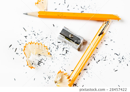 Broken pencil with metal sharpener and shavings. Broken pencil with metal sharpener and shavings. 28457422