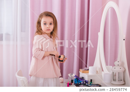 Cute little girl playing with cosmetics Cute little girl playing with cosmetics 28459774