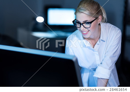 Charismatic young office manager using gadgets at Charismatic young office manager using gadgets at 28461654
