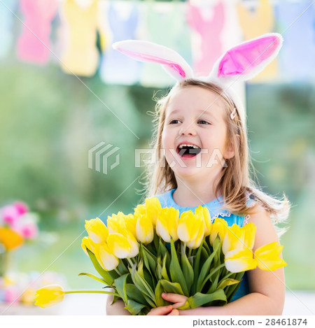 Little girl in bunny ears on Easter egg hunt 28461874