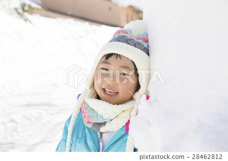 Child leaning against snow wall 28462812