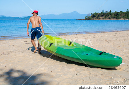 Man pulling a kayak to shore beach 28463607