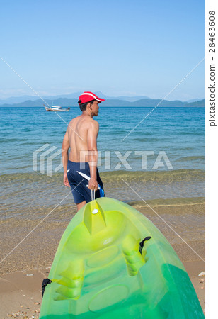 Man pulling a kayak to shore beach 28463608