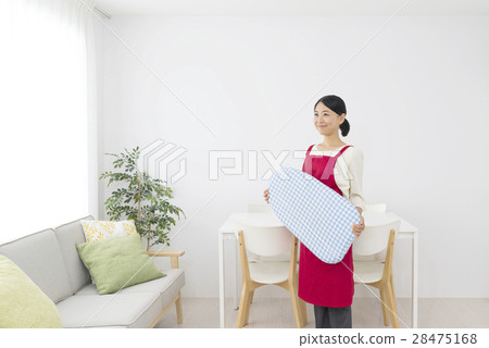 A smiling female apron with an iron A smiling female apron with an iron 28475168