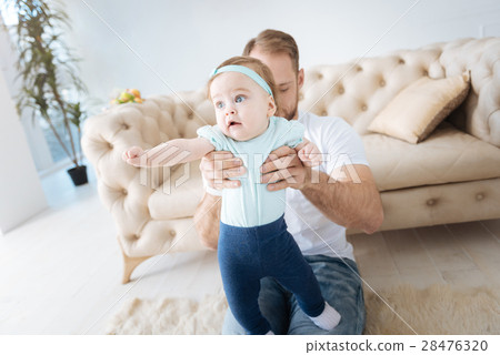 Curious kid in the arms of the father 28476320