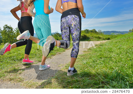 Three Female Joggers running together outdoors 28476470
