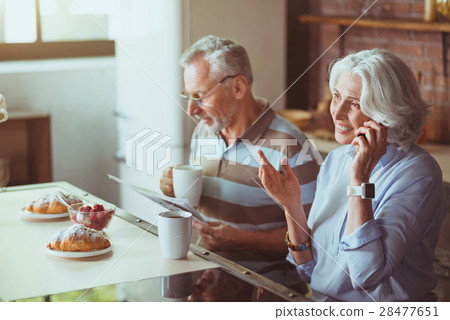 Positive aged couple having breakfast in the Positive aged couple having breakfast in the 28477651