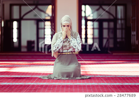 Young beautiful Muslim Woman Praying In Mosque 28477689