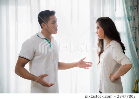 young man quarreling with his wife at home young man quarreling with his wife at home 28477802