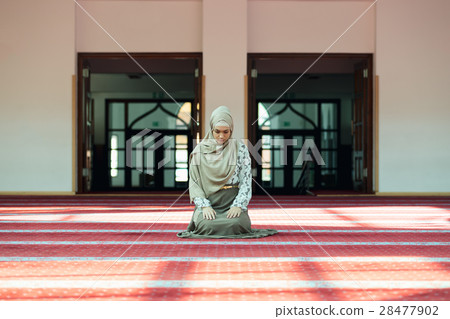Young beautiful Muslim Woman Praying In Mosque Young beautiful Muslim Woman Praying In Mosque 28477902