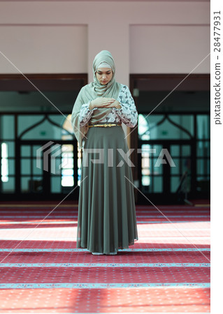 Young beautiful Muslim Woman Praying In Mosque Young beautiful Muslim Woman Praying In Mosque 28477931