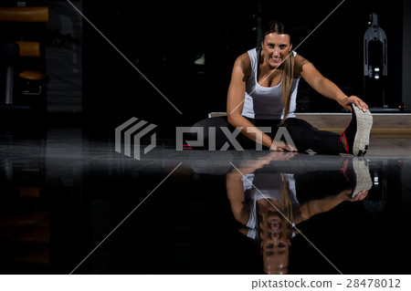 woman in a gym exercising, doing push ups. Dark woman in a gym exercising, doing push ups. Dark 28478012