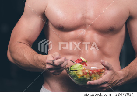 Shaped and healthy body building man holding a 28478034